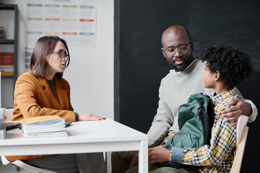 Teacher having conversation with parent