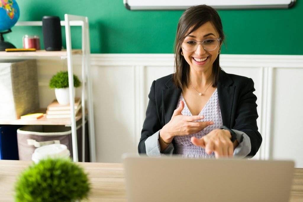 teacher uses her laptop to teach